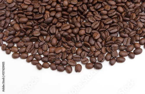 Roasted coffee beans on white.