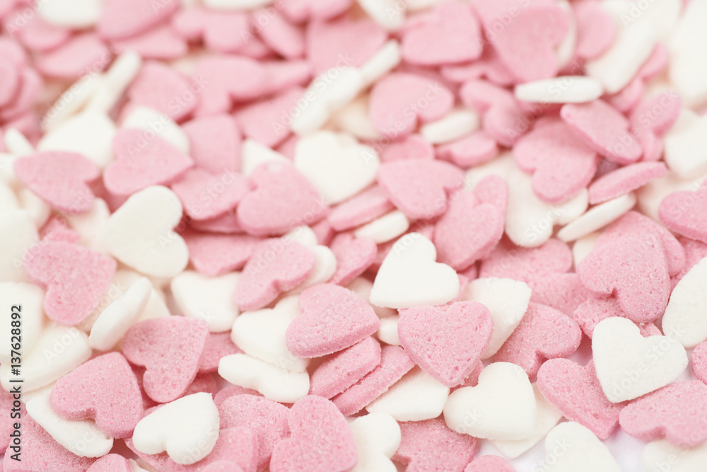 Surface coated with heart shaped sprinkles Surface coated with heart shaped sprinkles