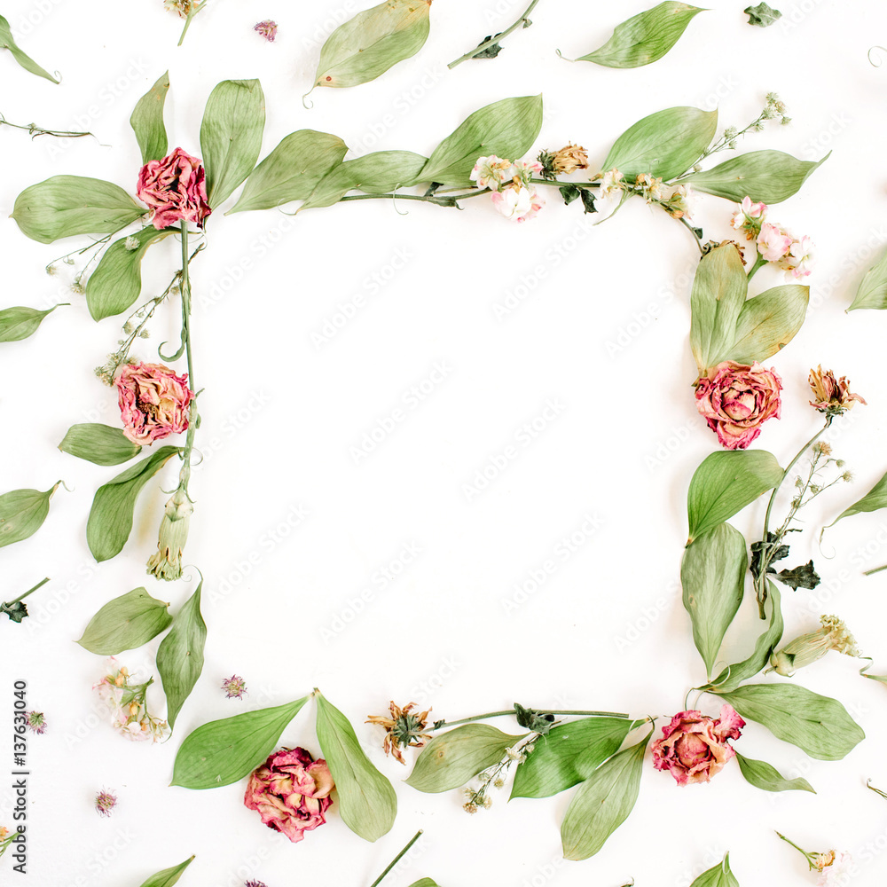 Round frame wreath pattern with roses, pink flower buds, branches and leaves on white background. Flat lay, top view. Flowers pattern