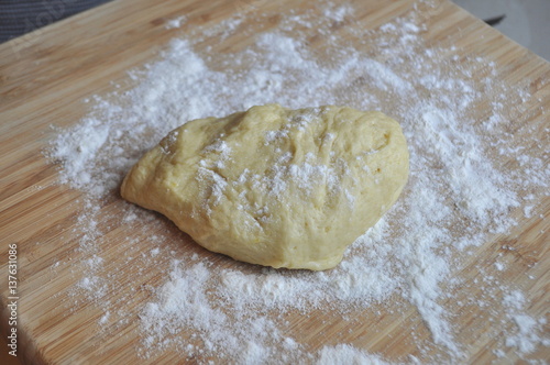 Yeast dough ready for use on a floured board