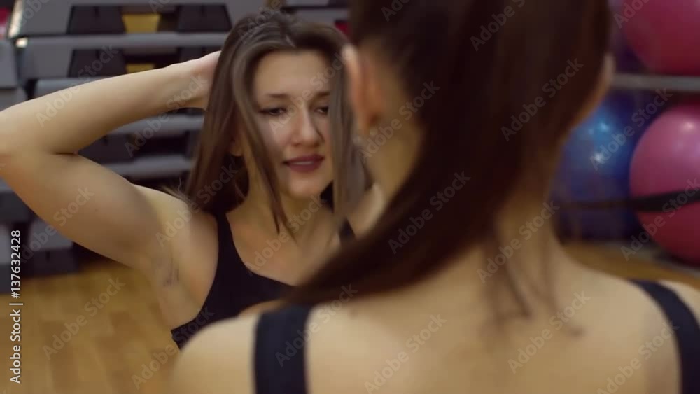 Girl and trainer engaged in fitness room, slow motion. Girl and trainer engaged in fitness room, slow motion.