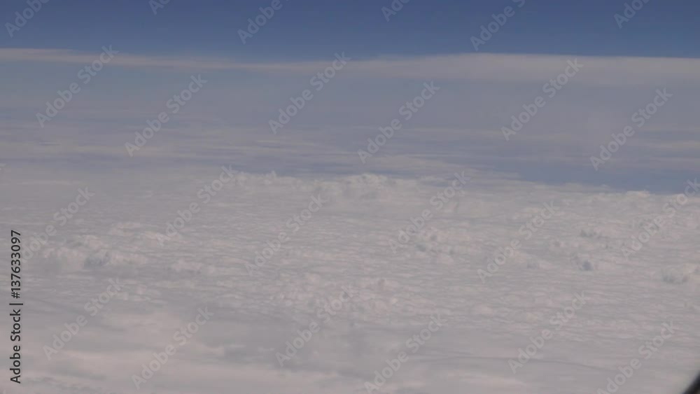 4K Traveling by air. Wonderful view of the sky and clouds with the light the sun from above, as seen through an airplane window-Dan 4K Traveling by air. Wonderful view of the sky and clouds with the light the sun from above, as seen through an airplane window-Dan