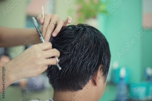 a man cutting hair at barber