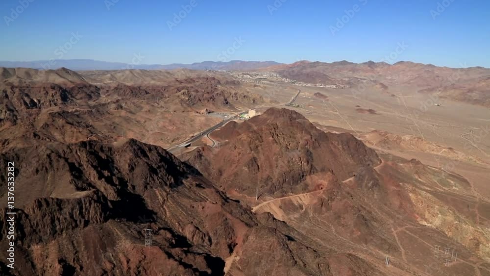 Aerial of the Mojave Desert, it stretches from the wedge-shaped across the Colorado River. In this video showing a wide view from a helicopter, a lone road cuts the desert. Aerial of the Mojave Desert, it stretches from the wedge-shaped across the Colorado River. In this video showing a wide view from a helicopter, a lone road cuts the desert.