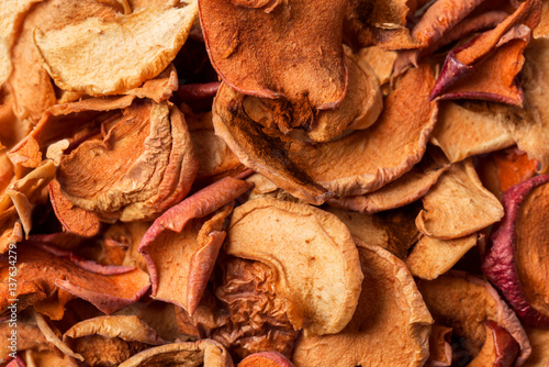 Naturally home kiln-dried organic apple slices textured background © pavelvinnik