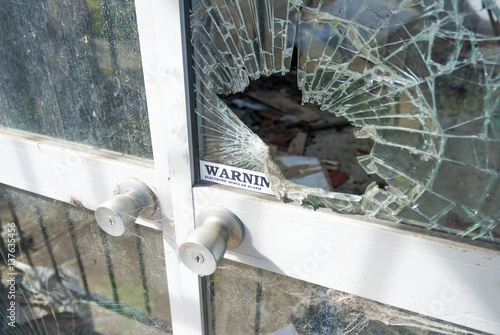 Front door shop smashed window security warning sticker Copyspace.
