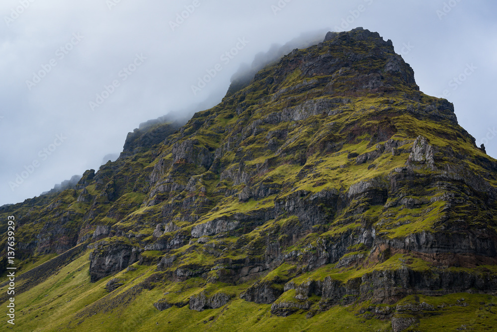 Cloud covered rocky mountain in Iceland