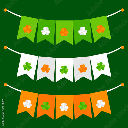 Colorful festive bunting with clover on green background photo