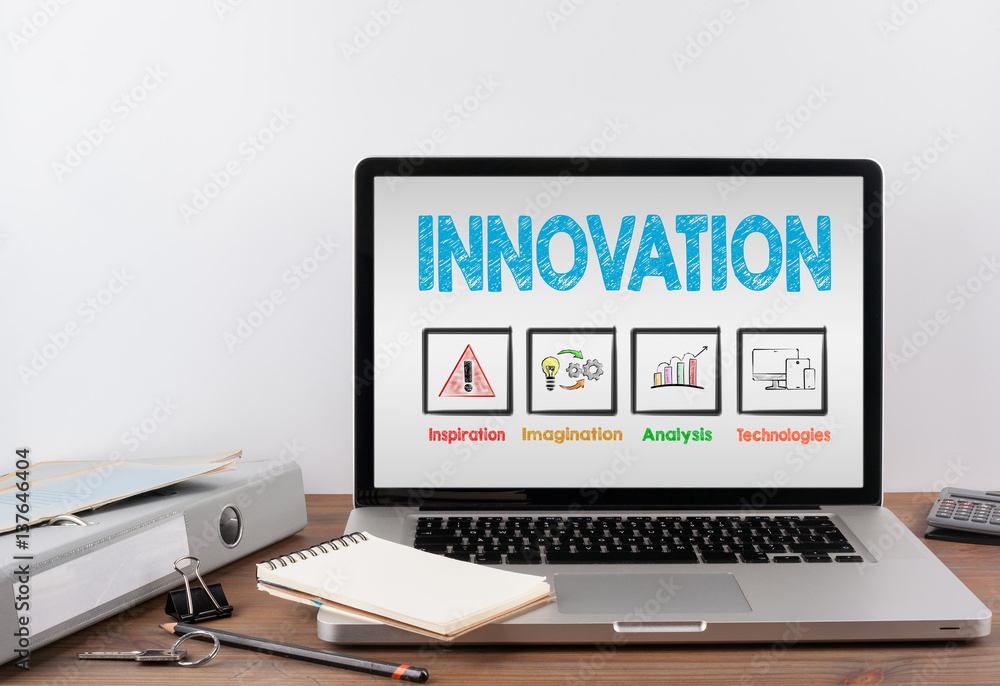 Innovation concept. Office desk with a laptop. Gray background Innovation concept. Office desk with a laptop. Gray background