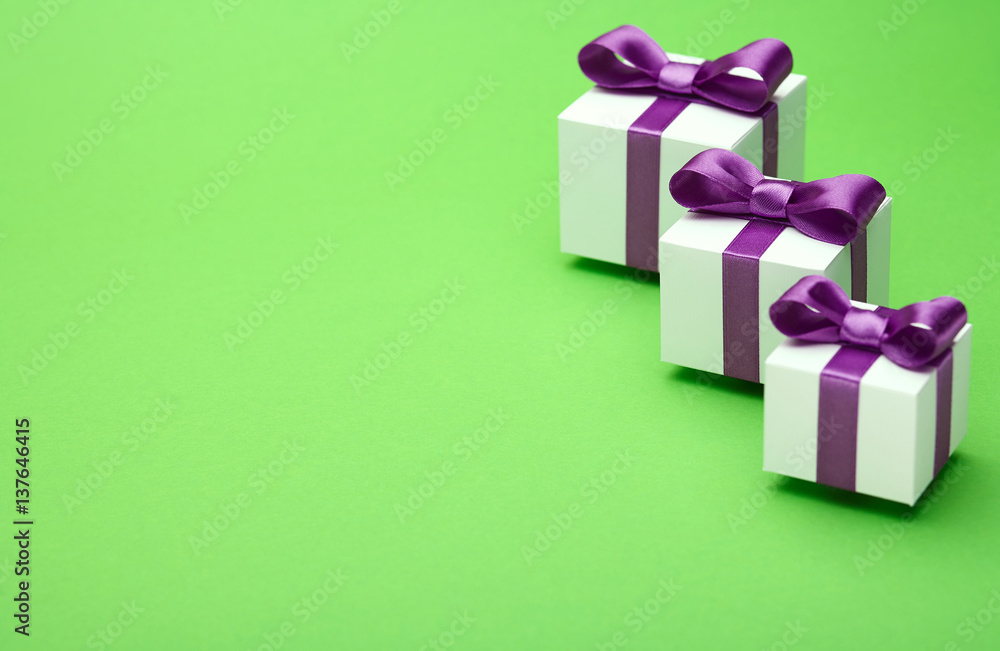 Gifts with satin bows on green Gifts with satin bows on green