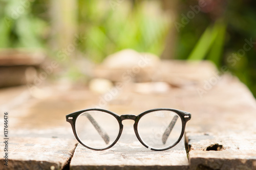 Vintage style of Old eyeglasses on wooden table.