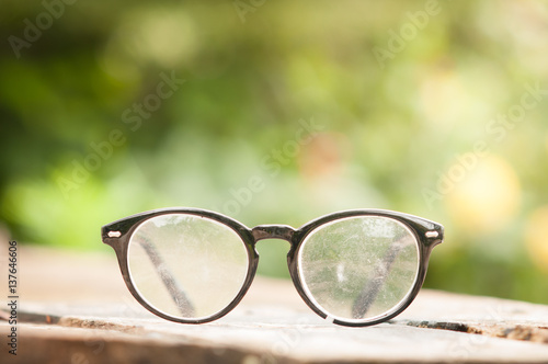 Vintage style of Old eyeglasses on wooden table.