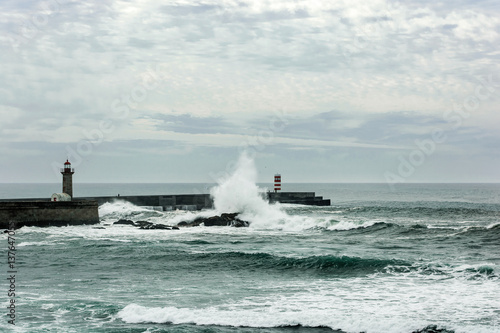 stormy sea waves over lighthouse in Porto, Portugal