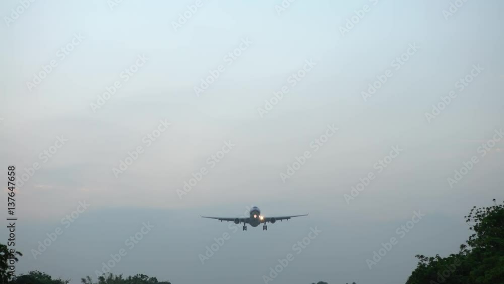 4K A Commercial Passenger Aircraft Across Flying Over Head. Jet Airplane Take Off Landing Or Parking At national Airport. Plane fly in day time-Dan 4K A Commercial Passenger Aircraft Across Flying Over Head. Jet Airplane Take Off Landing Or Parking At national Airport. Plane fly in day time-Dan