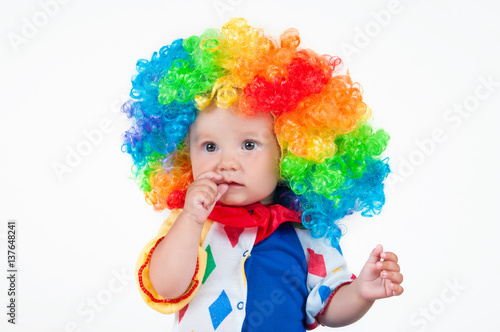 Child clown with a red nose multicolored wig in with balls