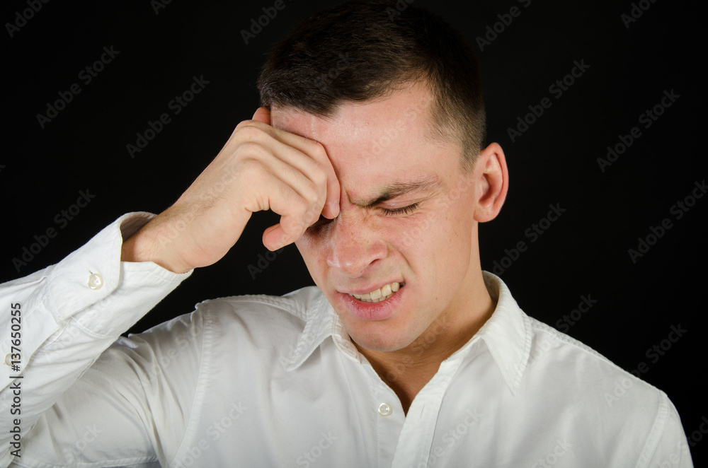Stress and problems. Young man with a headache. Stress and problems. Young man with a headache.
