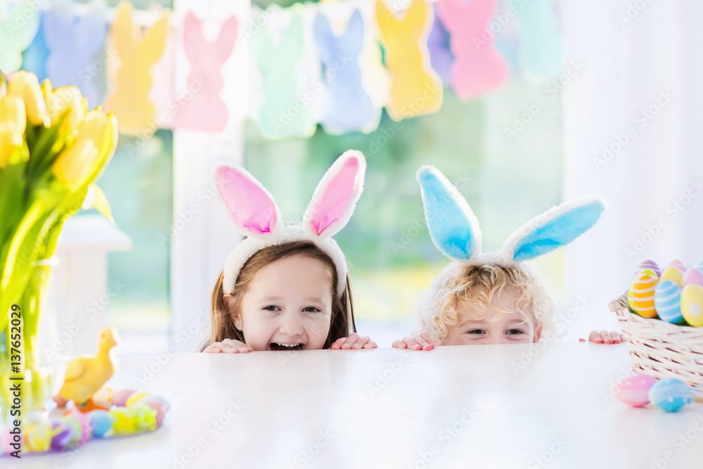 Fototapeta premium Kids with bunny ears on Easter egg hunt