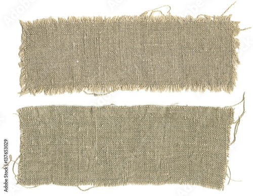 Pieces of burlap with torn edges isolated on white background
