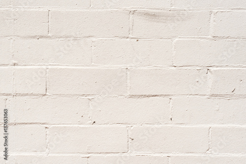 Imperfect, aged, white painted exterior brick wall © Natalie Board