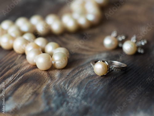 Side view on Luxury pearl set. Pearl earrings and ring close up