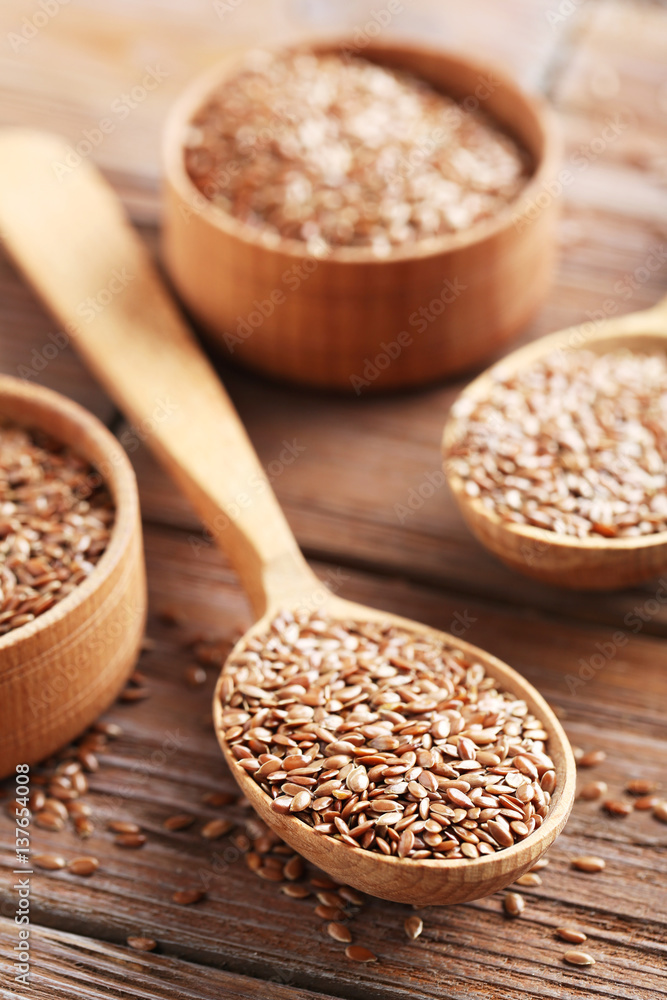 Brown flax seeds on a wooden table Brown flax seeds on a wooden table