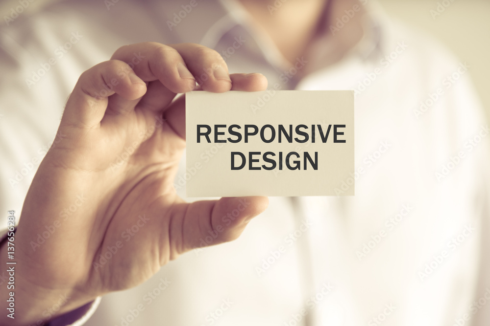 Businessman holding RESPONSIVE DESIGN message card Businessman holding RESPONSIVE DESIGN message card