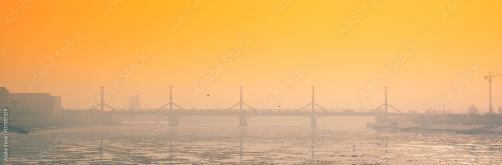 Winter frozen city sunset landscape with bridge