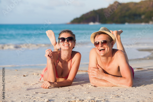happy young couple lying and having fun on a tropical beach © el.rudakova