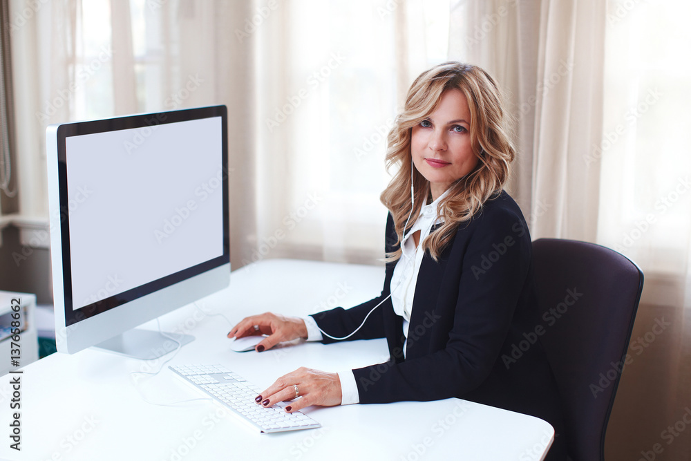 Beautiful business women at her personal office working on her desk.