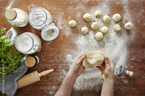 Bilde på lerret hands rolling out dough view from above vivid kitchen scene
