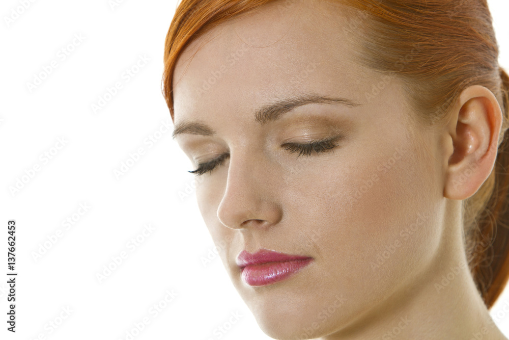 Serious, thoughtful young woman with closed eyes