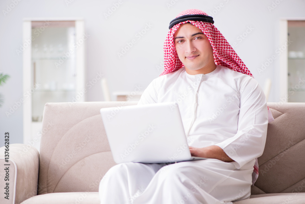 Young arab businessman working with laptop on sofa Young arab businessman working with laptop on sofa