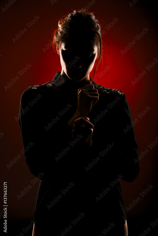 Silhouette portrait of a young girl in a black shirt