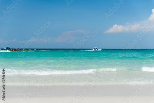 Beautiful gentle wave at the shallow beach with blue sky