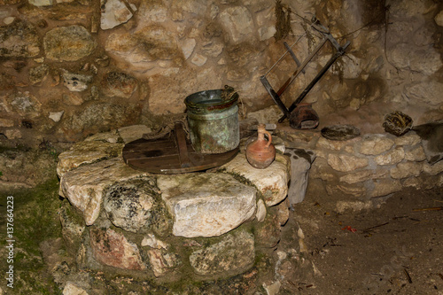 The Old bucket and the clay jug on the water well in Nazareth Village, Israel.