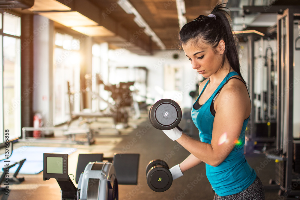 Young woman doing exercise with lifting weights. Young woman doing exercise with lifting weights.