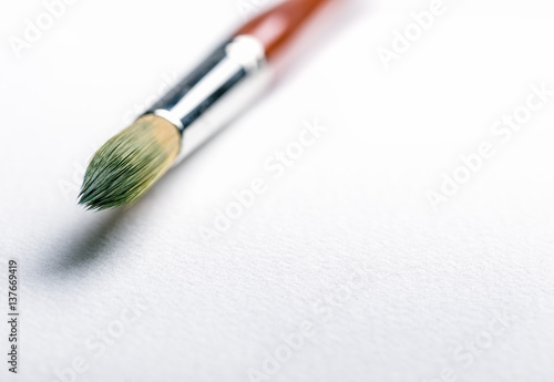 Close up of paint brushes on a white background