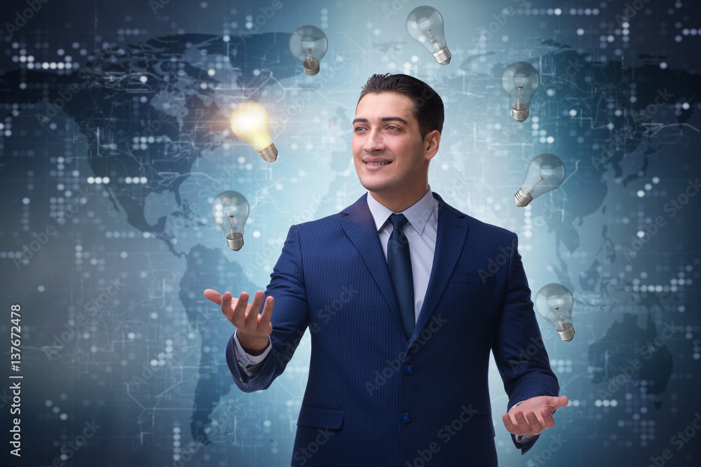 Businessman juggling lightbulbs in new idea concept Businessman juggling lightbulbs in new idea concept