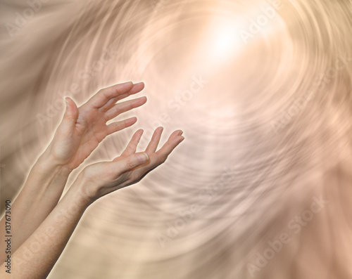 Divine Light Sacred Source of All That Is - female hands reaching up towards a glowing while light amidst a pale flesh colored linear matrix energy field with plenty of copy space