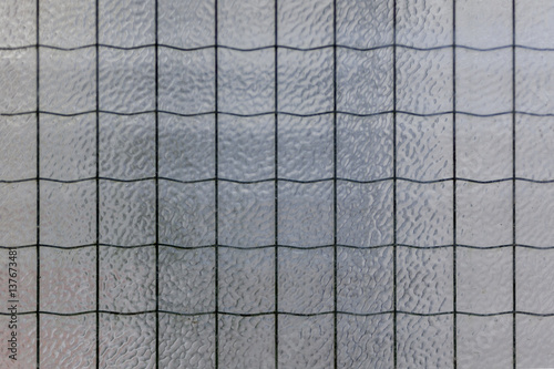 Fotografi Bubbled opaque textured white glass with waved wire inside