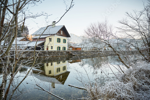 Fototapeta House at the river with frost and ice