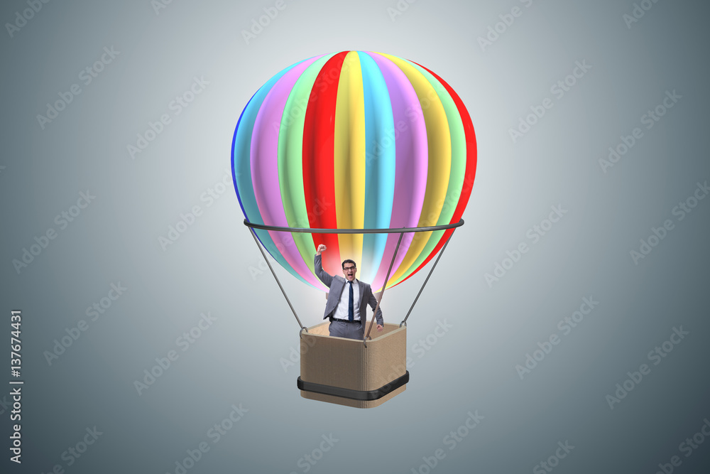 Fototapeta premium Businessman flying on balloon in challenge concept