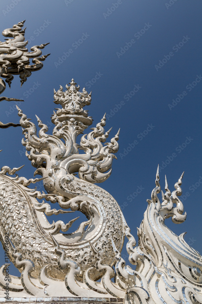 Sculpture detail and decoration in all-white buddhist temple Wat Rong Khun in Chiang Rai, Thailand