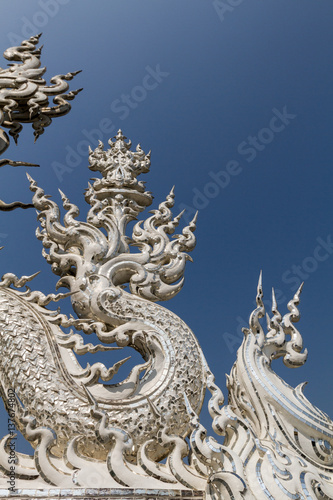 Sculpture detail and decoration in all-white buddhist temple Wat Rong Khun in Chiang Rai, Thailand © Cyrsiam