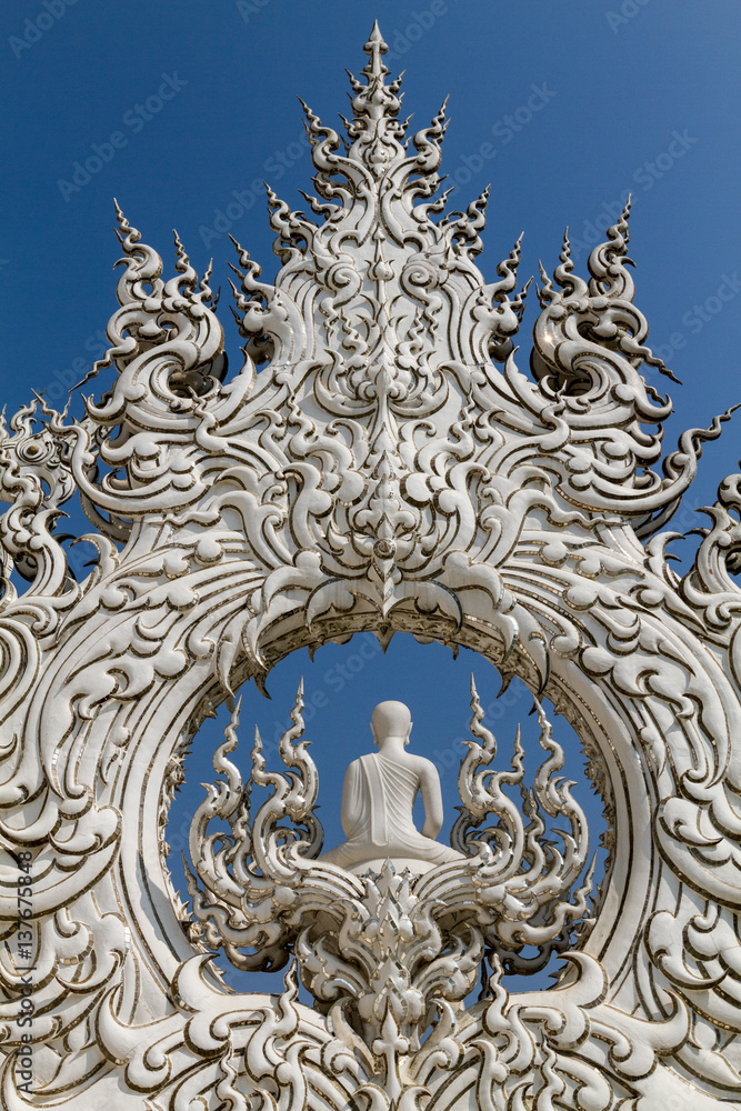Sculpture detail with white Buddha in all-white buddhist temple Wat Rong Khun in Chiang Rai, Thailand, symbol of creativity, serenity and peace