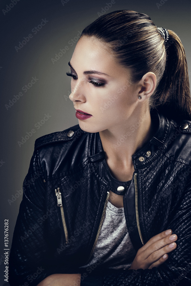 Portrait d'une jeune femme les cheveux tirés, de profil, le regard sur le coté Portrait d'une jeune femme les cheveux tirés, de profil, le regard sur le coté