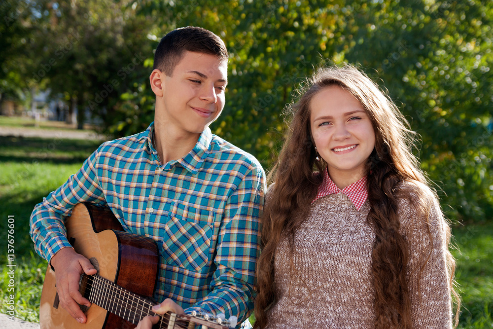 Fototapeta premium teenage boy and girl, guitar