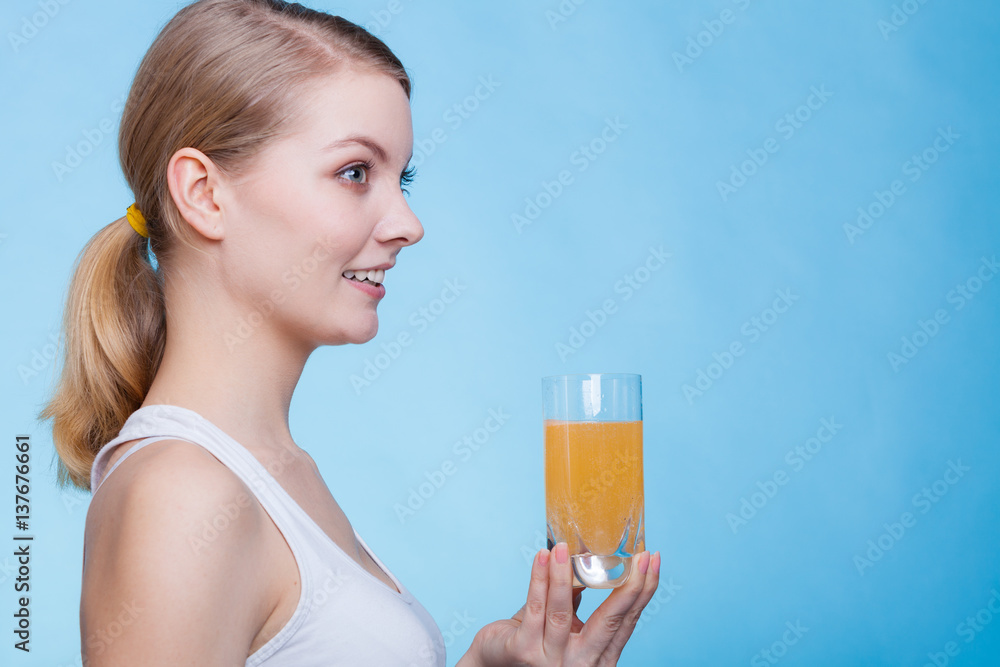 Woman holding glass of orange flavored drink Woman holding glass of orange flavored drink