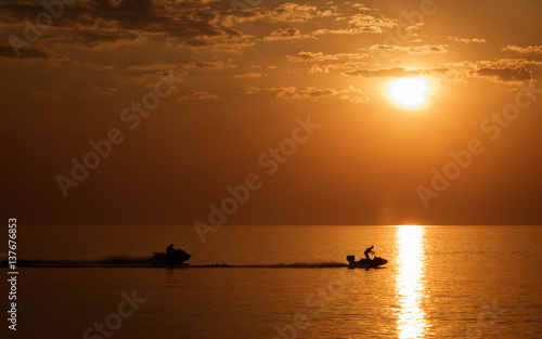 Silhouette jet ski in the sea landscape background