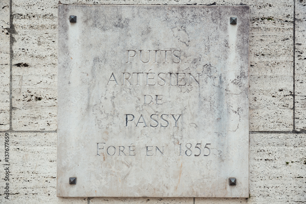 Plaque of the natural source of Passy in the middle of Paris